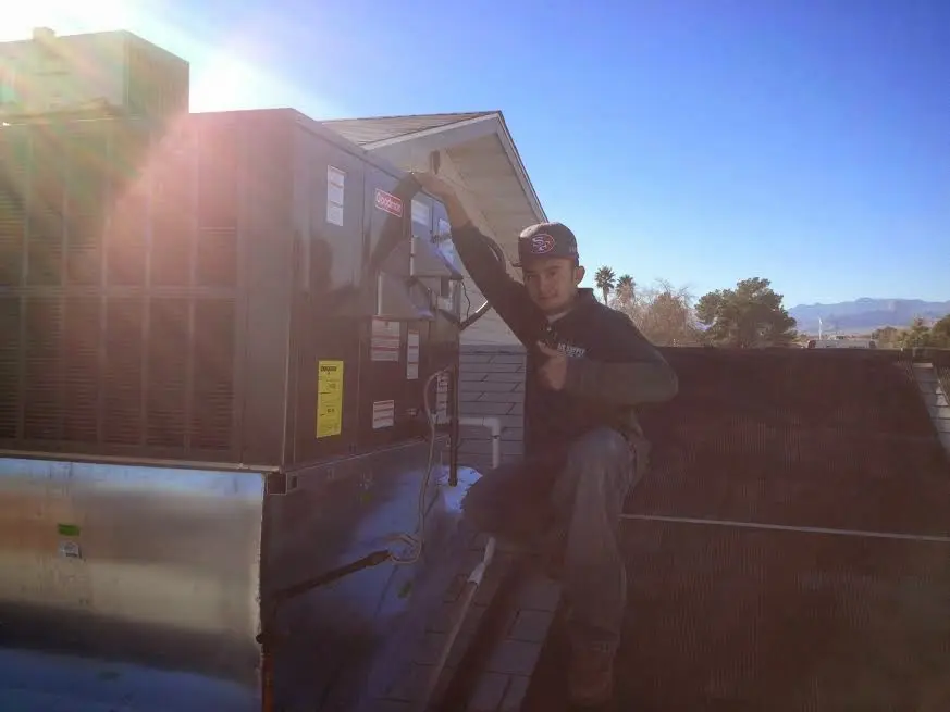 HVAC technician performing AC Tune-Up on a rooftop unit in Silver Lakes